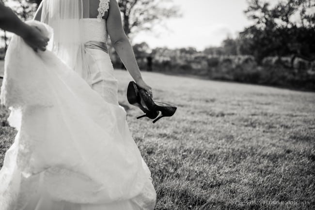priam vineyards wedding photos bride walking with shoes
